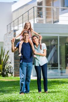 Family in front of house - Insurance Agency in West Long Branch, NJ Family in front of house - Insurance Agency in West Long Branch, NJ