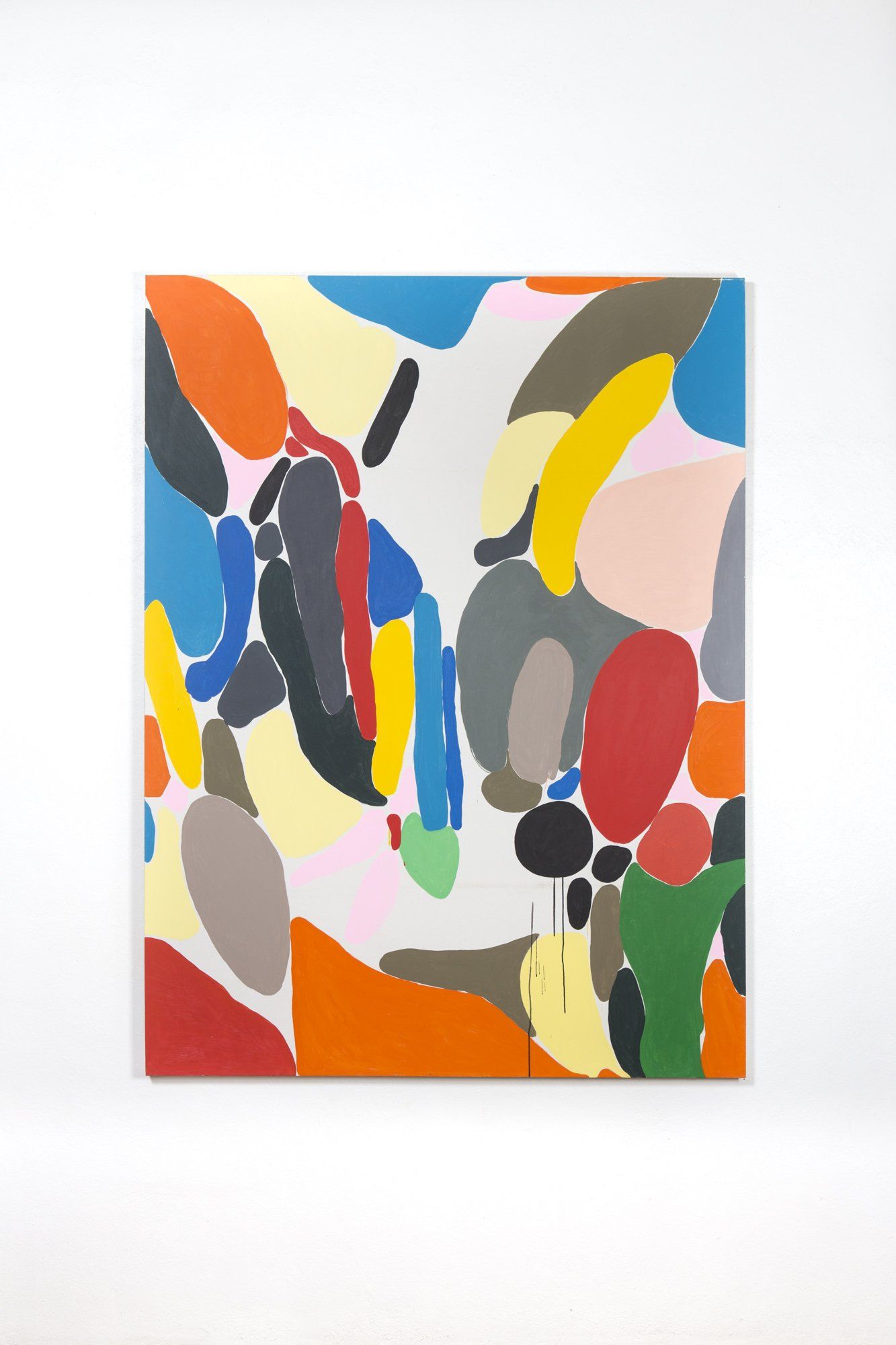 A colorful painting is hanging on a white wall.