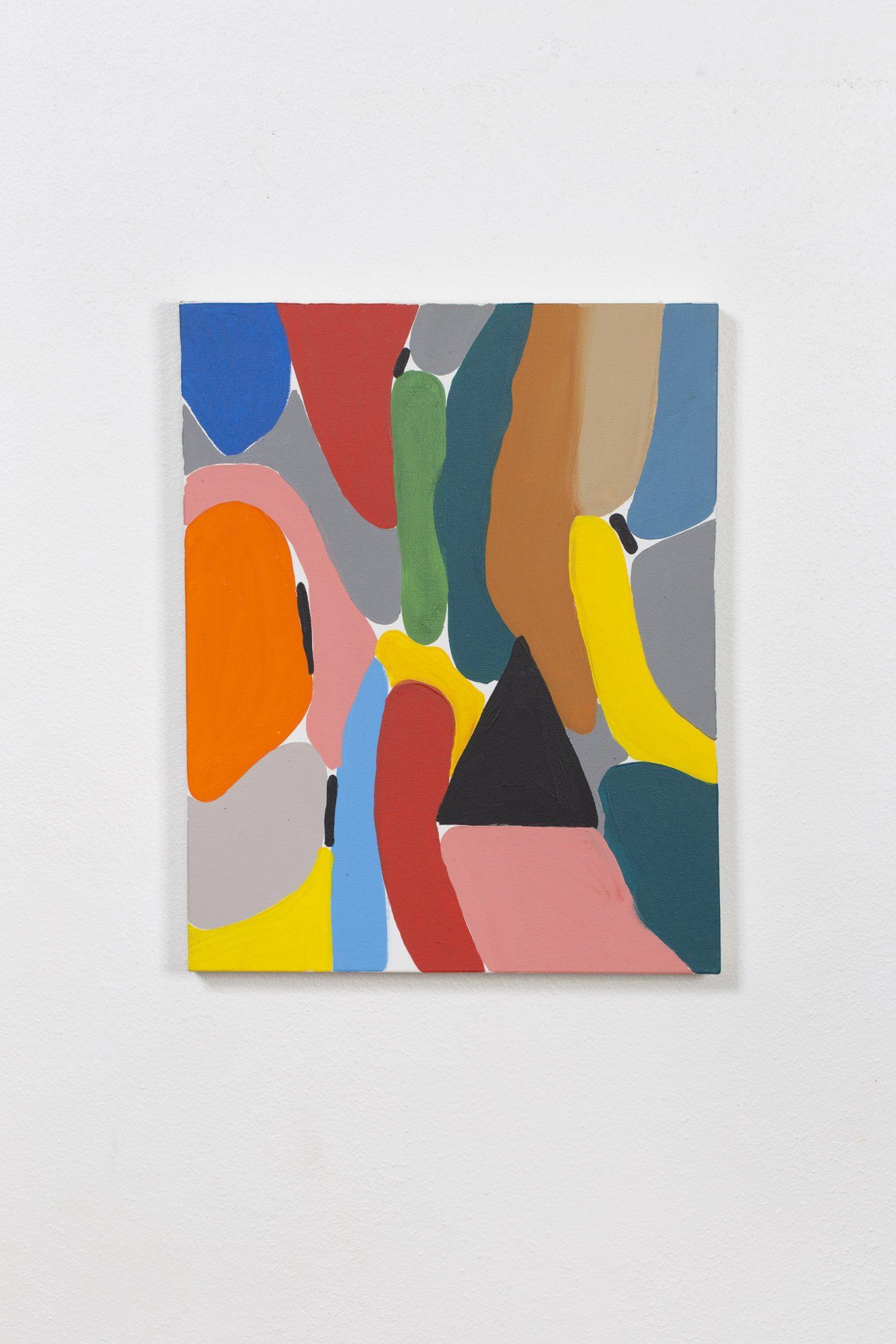 A colorful painting is hanging on a white wall.