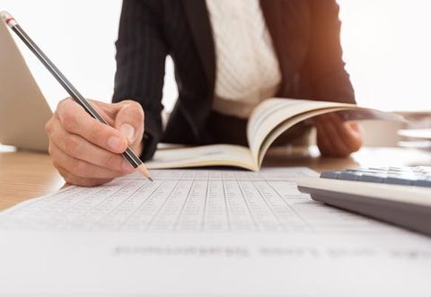Accountant Balancing a Ledger — Document Files With A Calculator In Baton Rouge, LA Accountant Balancing a Ledger — Document Files With A Calculator In Baton Rouge, LA