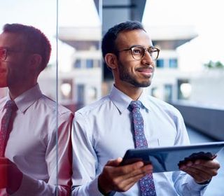 Personal Tax Preparation — A Man Holding A Tablet In Baton Rouge, LA Personal Tax Preparation — A Man Holding A Tablet In Baton Rouge, LA