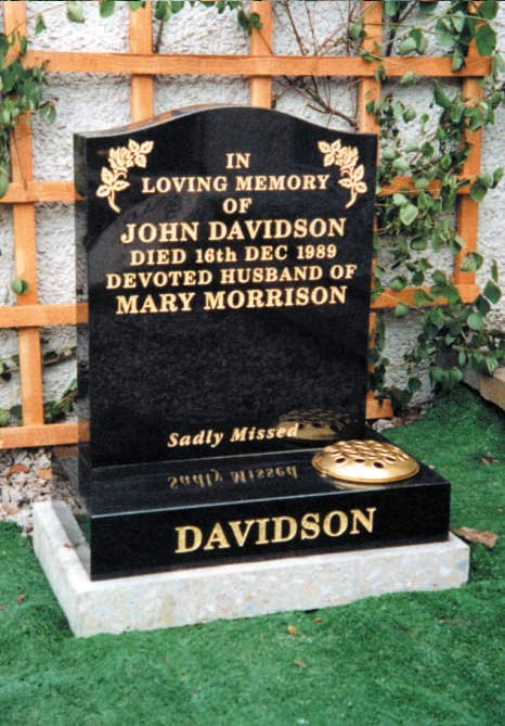 black memorial stone with golden design