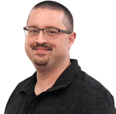Portrait of a smiling man with glasses and a dark sweater against a white background