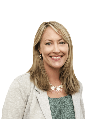Smiling woman in a light blazer and green top against a white background.