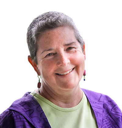 Smiling person in a purple jacket and green shirt against a white background