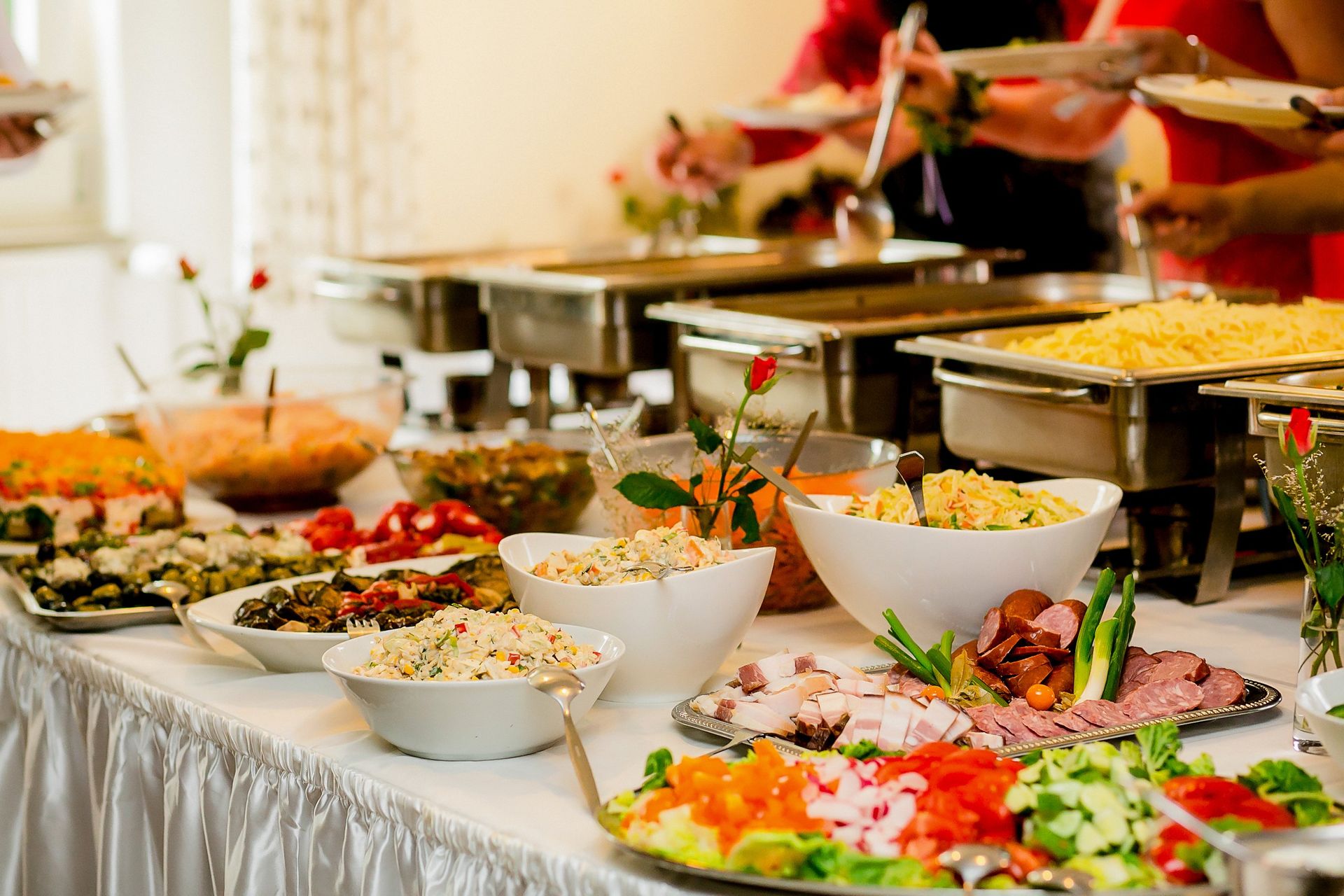 A buffet table filled with lots of different types of food.