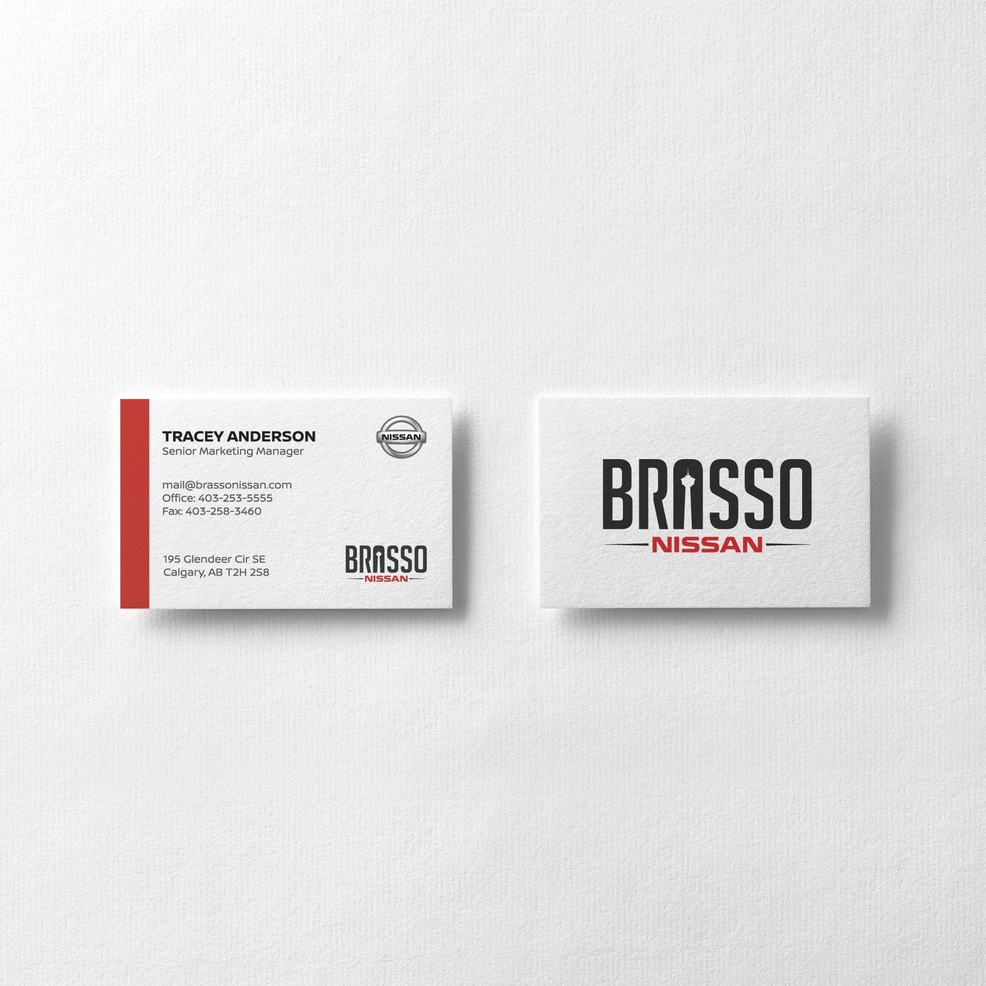 Two business cards for brasso nissan on a white background