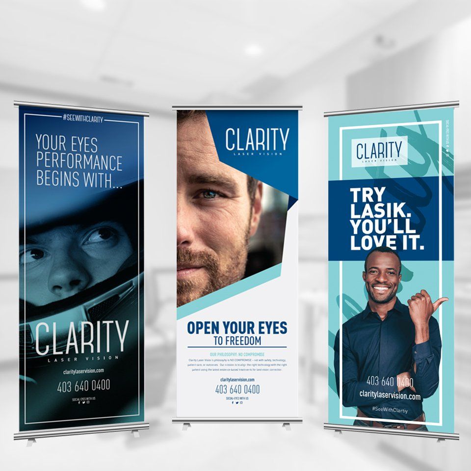Three banners for a company called clarity are displayed in a room.