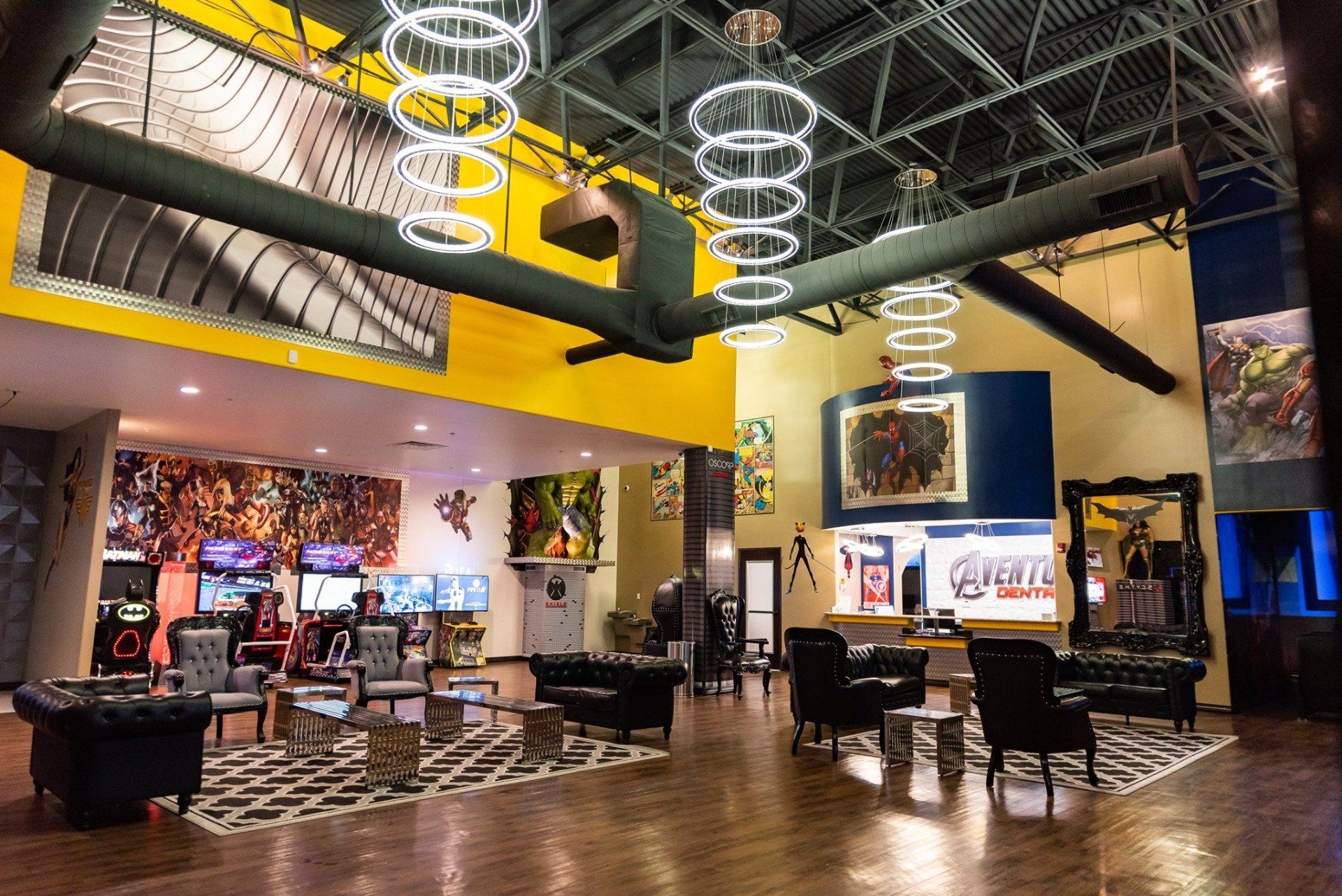 Modern arcade lounge with neon lights, gaming machines, and a high-ceiling industrial interior