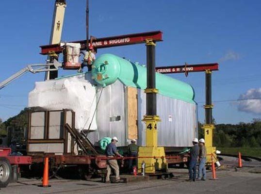 worker moving large pipes