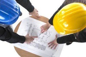construction workers examining plans construction workers examining plans