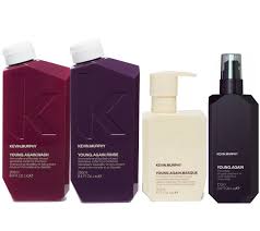 Four bottles of Kevin Murphy hair products. Includes shampoo, conditioner, mask, and spray, in purple, cream, and black.