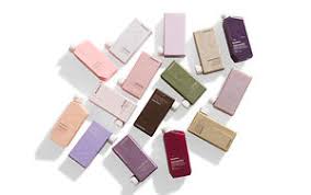 Assorted pastel-colored rectangular bottles arranged on a white surface.