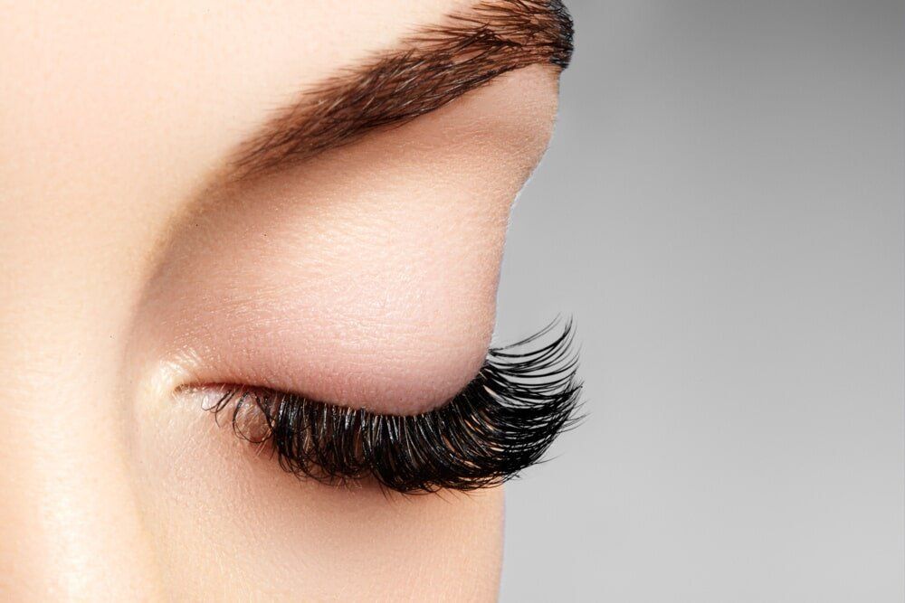 A Closed Eye with Long Black Eyelashes and Soft Pink Eye Shadow — Gorgeous Brows Eyebrow Threading in Caloundra, QLD