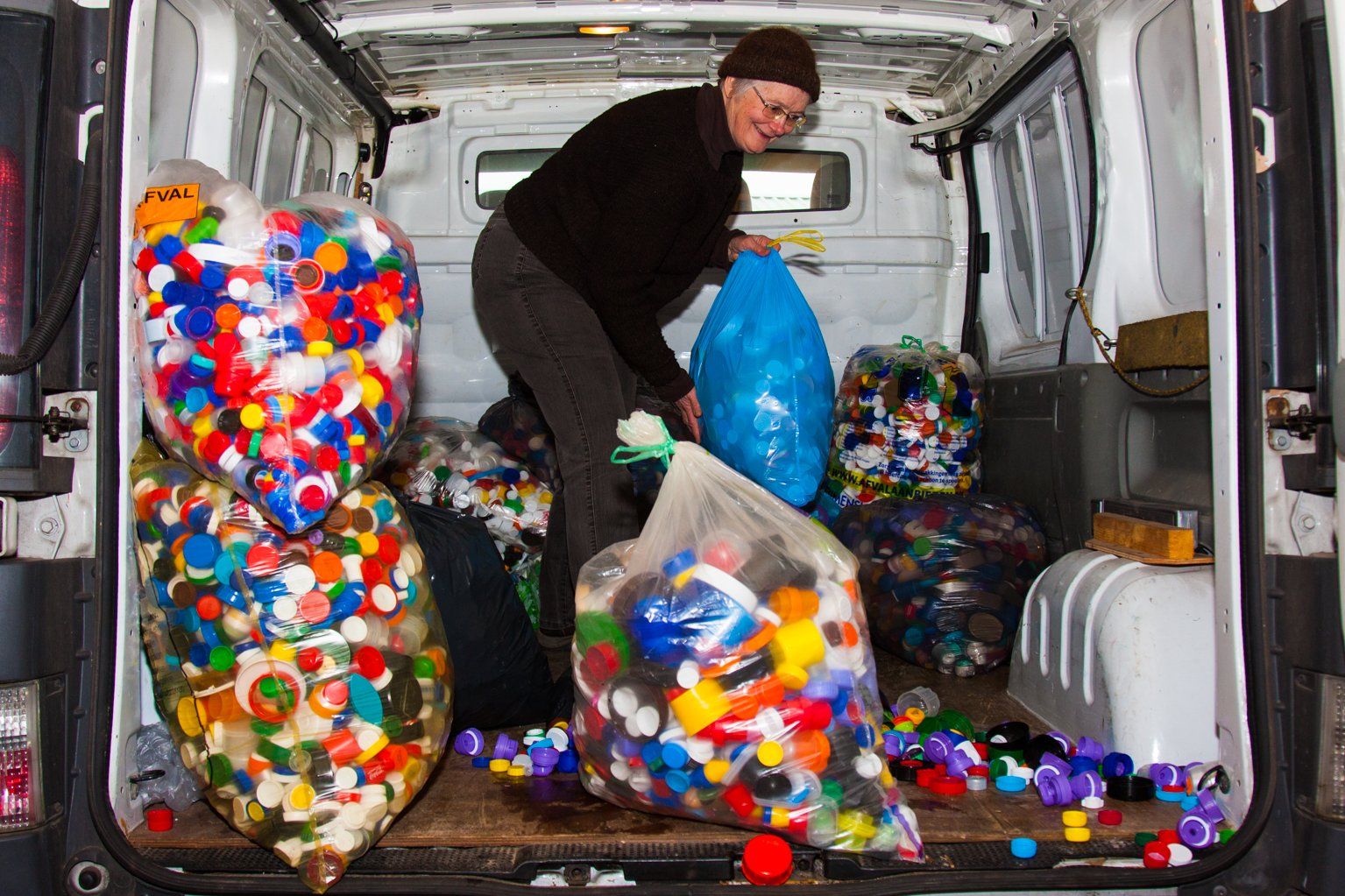Annemarie bezig met het leeg maken van haar bestelbus.