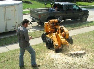 Man grinding stump - Stump grinding in Irving, TX Man grinding stump - Stump grinding in Irving, TX