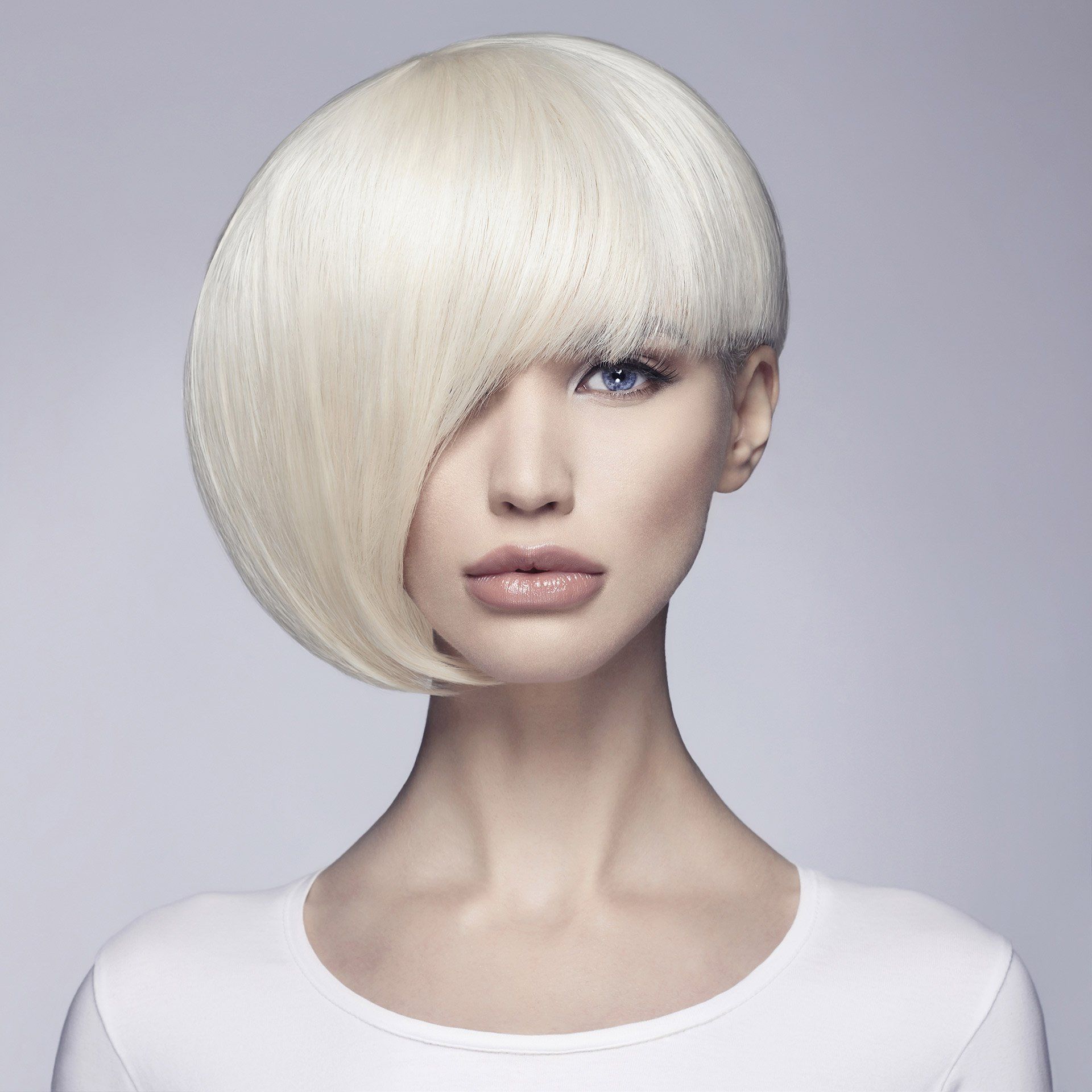 A woman with short white hair and a white shirt