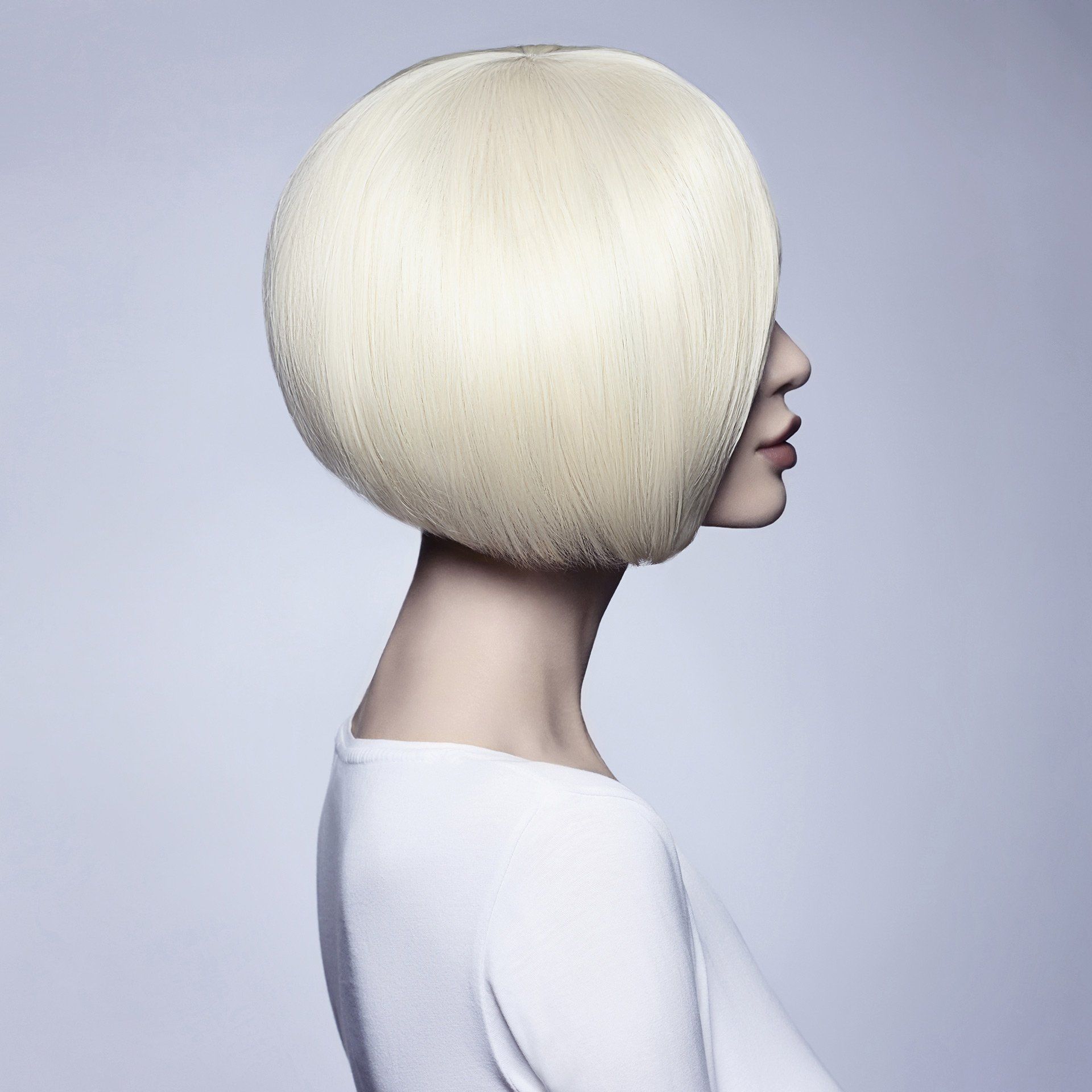 A woman with blonde hair is wearing a white shirt