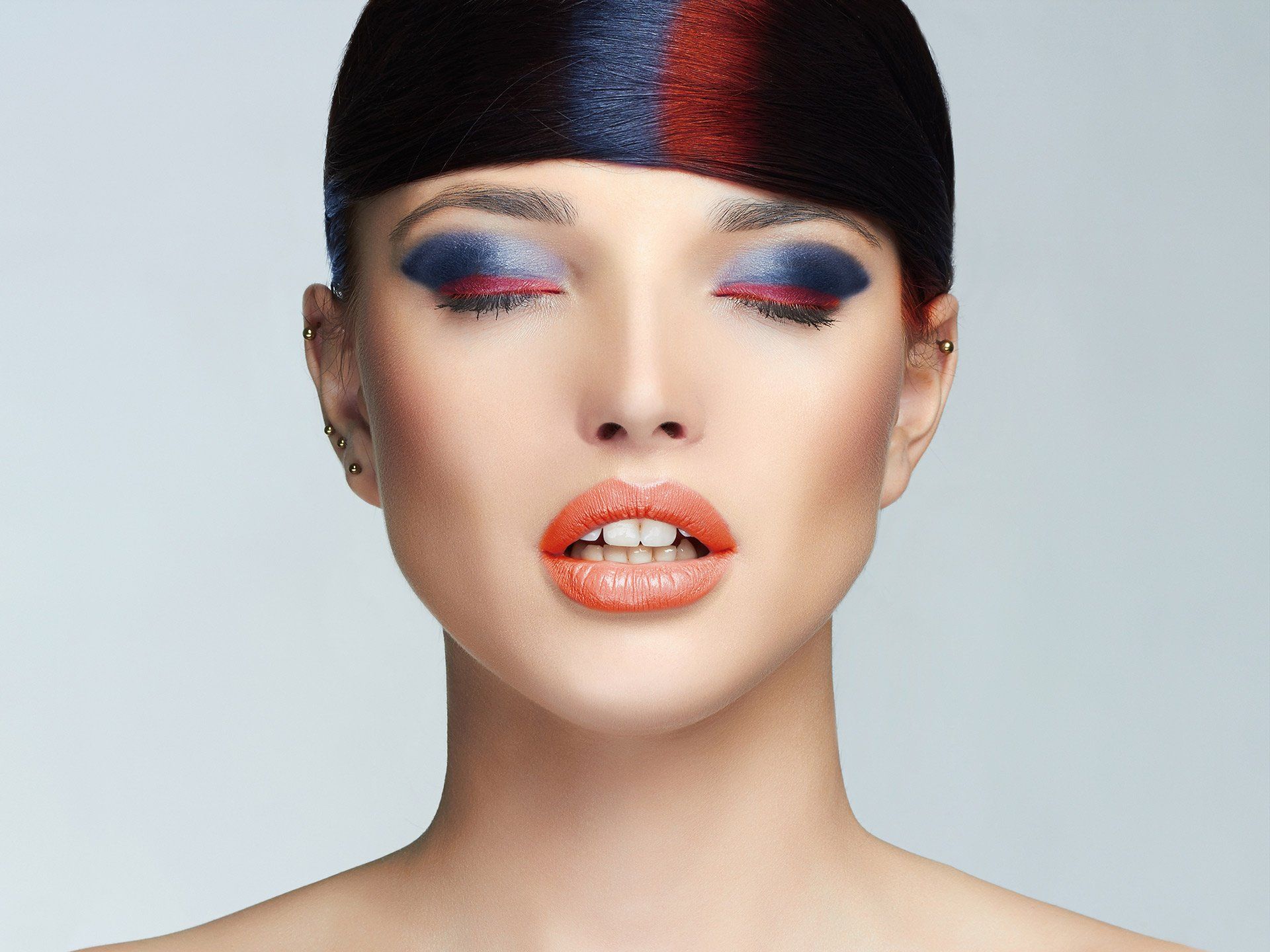 A close up of a woman 's face with a hat on
