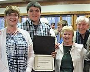 A group of people are posing for a picture while holding a certificate.