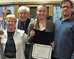 A group of people standing next to each other holding a certificate.