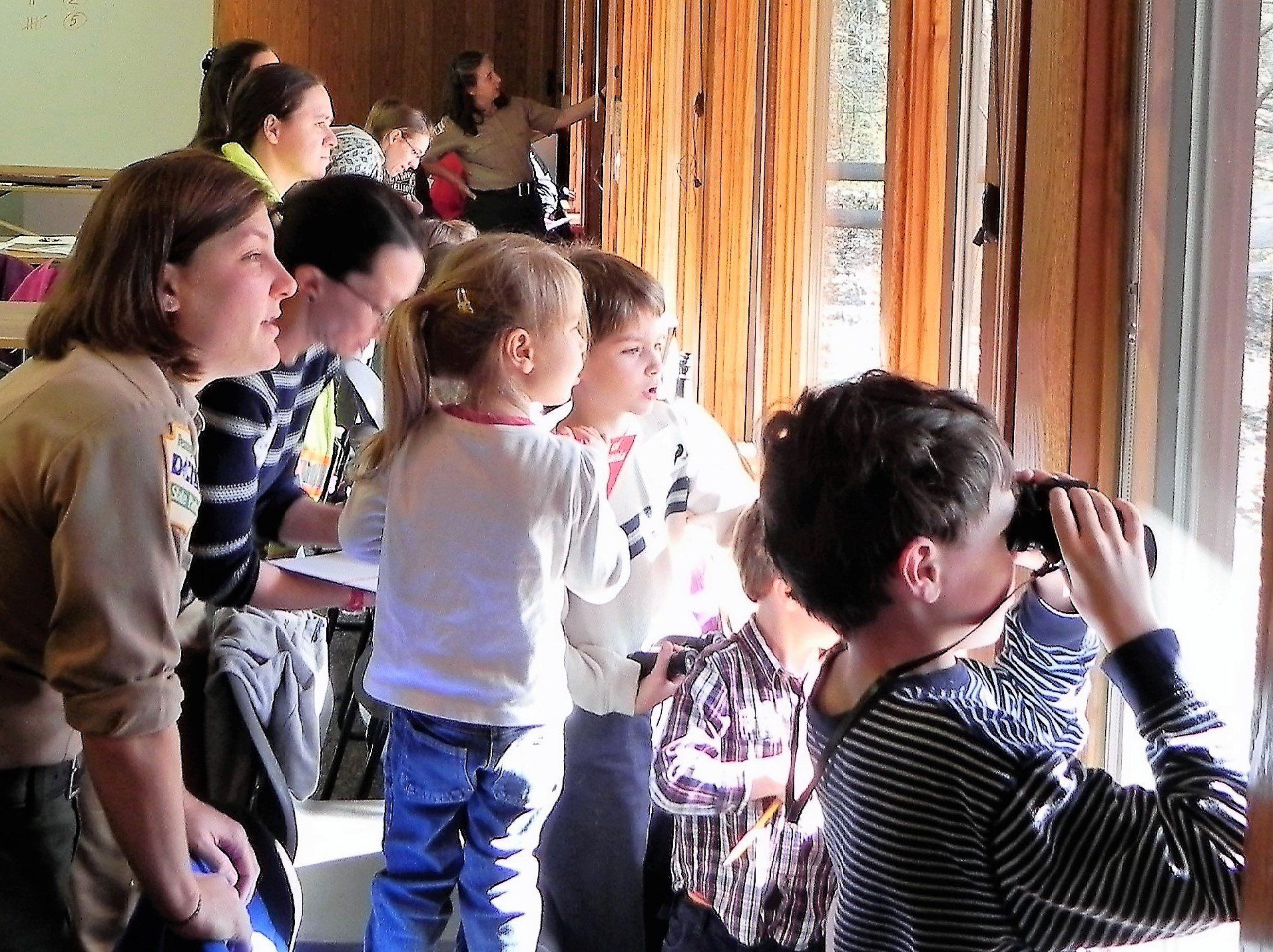 A group of people are looking out of a window