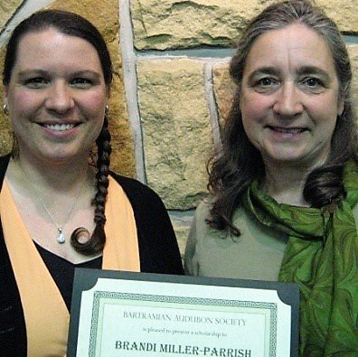 Two women standing next to each other holding a certificate that says brandi miller parrish