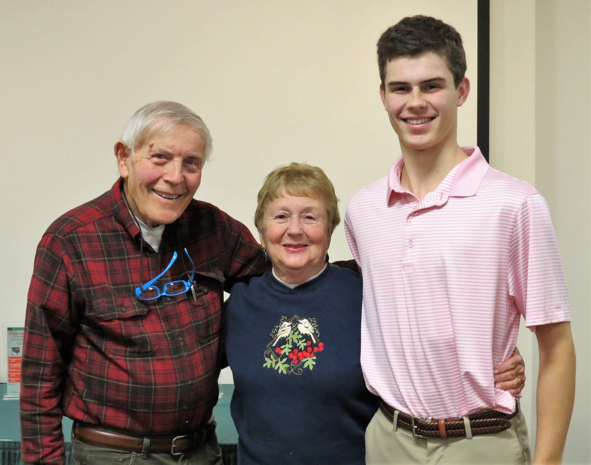 A man and two women are posing for a picture together