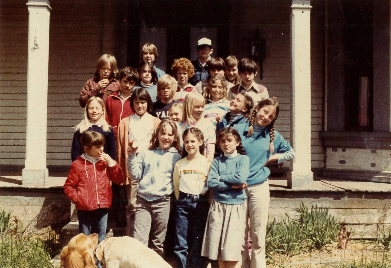 old photo of students standing outside of the Riverside School