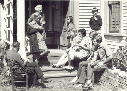 Teachers and students sitting outside of the old Riverside school