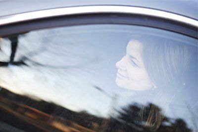 woman looking through car window woman looking through car window