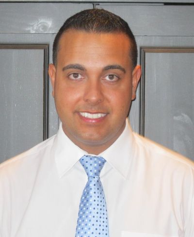 Licensed Chiropractor — Doctor Showing Spine Model in New Bedford, MA Licensed Chiropractor — Doctor Showing Spine Model in New Bedford, MA