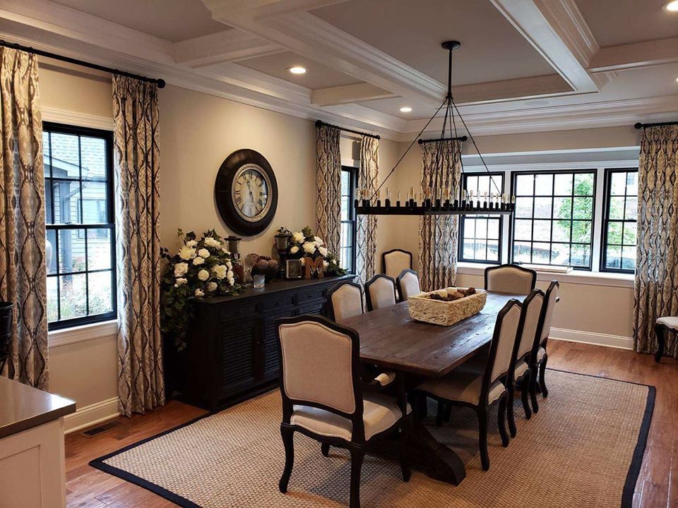 A formal dining room with patterned custom drapery