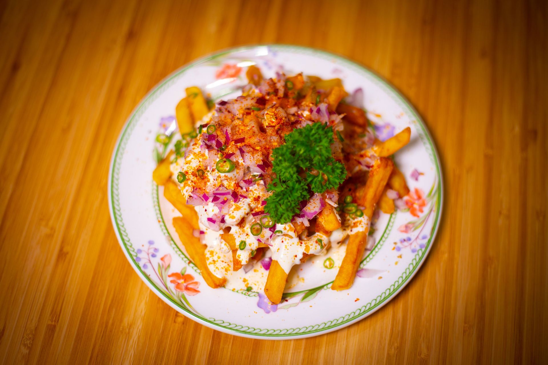 A plate of food is sitting on a wooden table.