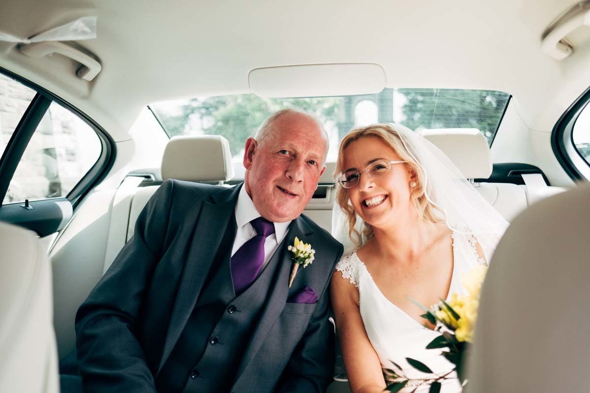 bride and father waiting in car before wedding ceremony timoleague