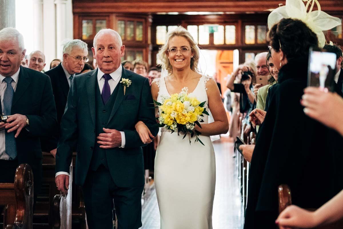 Bride and father walking down the aisle at Blessed Virgin Mary Timoleague