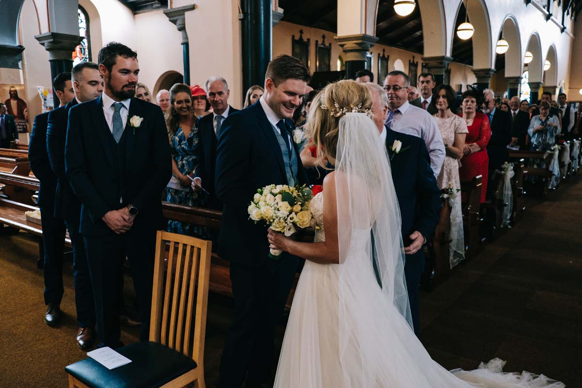 clonakilty wedding photographer - bride meets groom and end of aisle 
