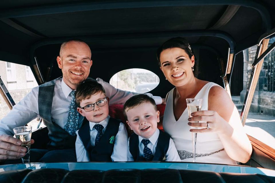 group photo with family wedding in vintage car