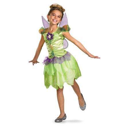A little girl in a tinkerbell costume is standing with her arms outstretched