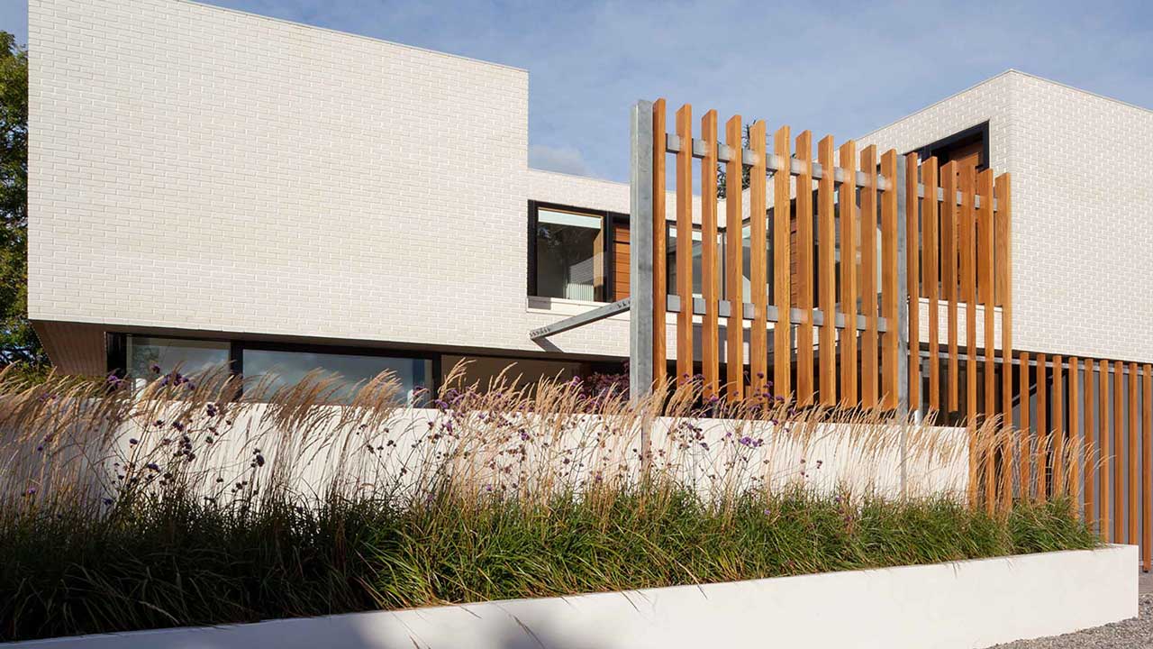 Modern home with a glassy exterior and white brick details in Clontarf