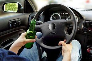 Man Holding A Bottle While Driving — Criminal in Suite C, Delco, NC Man Holding A Bottle While Driving — Criminal in Suite C, Delco, NC