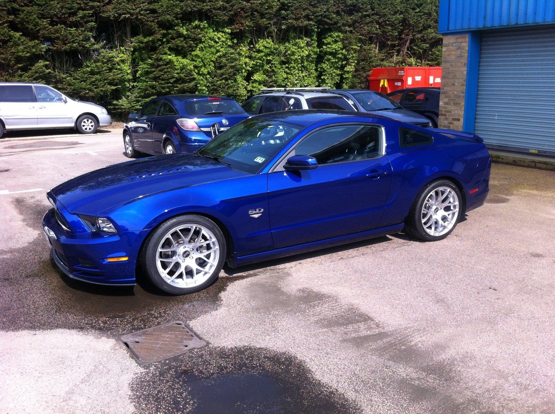 Blue car outside the garage