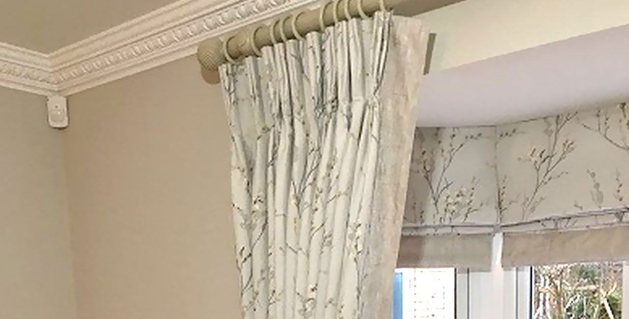 Curtains with triple pleat heading tape on a wooden pole