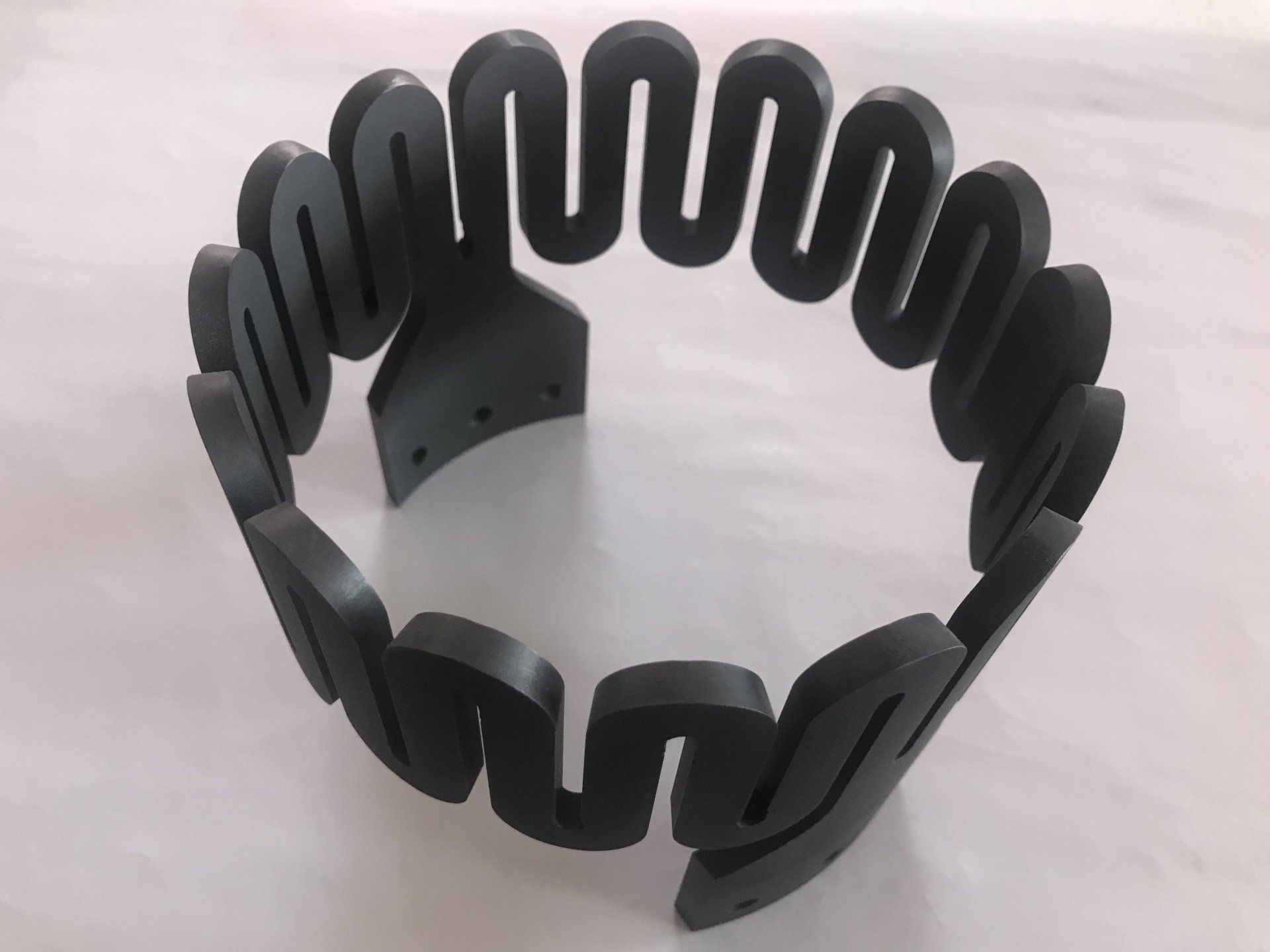 Ein schwarzes Armband mit einem Wirbelmuster darauf