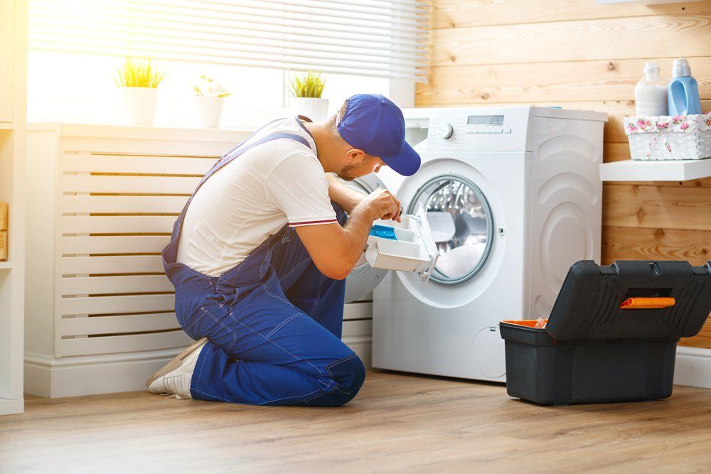 Appliance Service — Man Repairing a Washing Machine in Voorhees, NJ