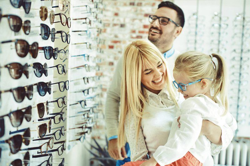 Happy Family Browsing Eyeglasses — Binghamton, NY — Binghamton Eye Associates
