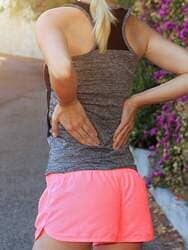Woman Suffering Body Pain - Lower Back in Laguna Beach, CA Woman Suffering Body Pain - Lower Back in Laguna Beach, CA