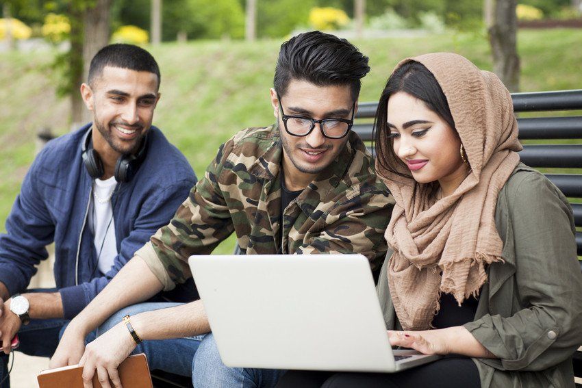 students on laptop learning english