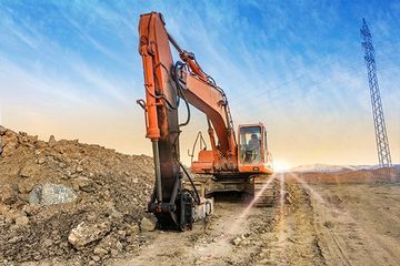 Excavator removing the waste materials from the construction land
