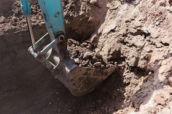 Excavator removing sand